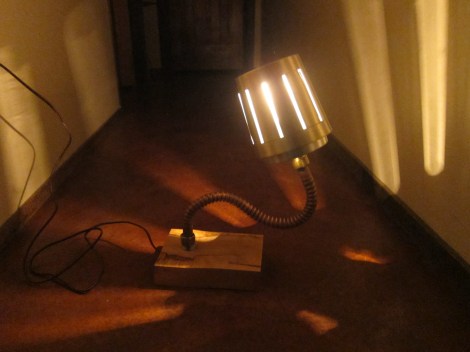 Scrap wood, copper pipe, and reused lighting.