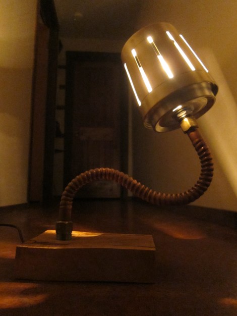 Scrap wood, copper pipe, and reused lighting.